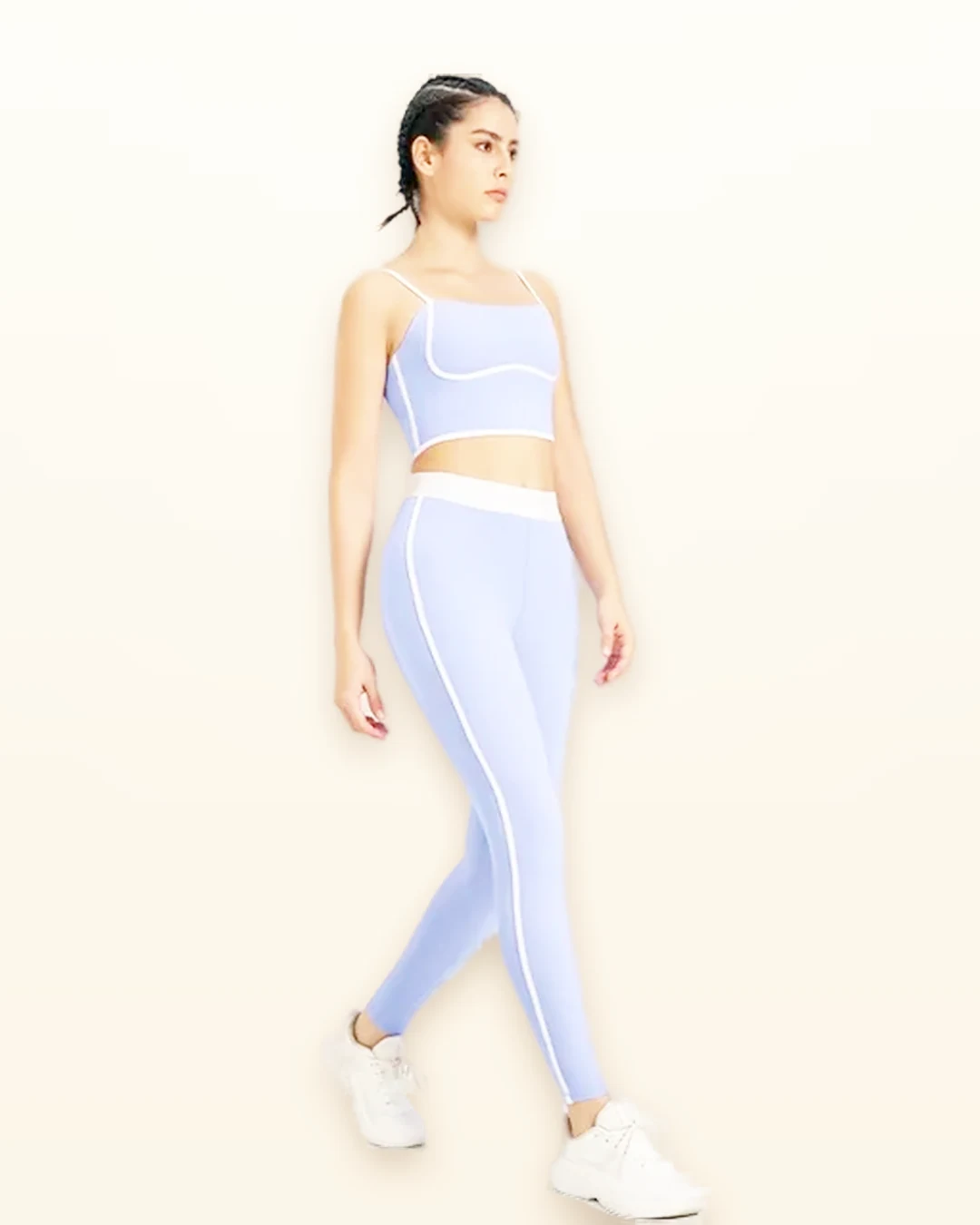 Model walking in a periwinkle two-piece naked-feel yoga set manufactured by Walundi