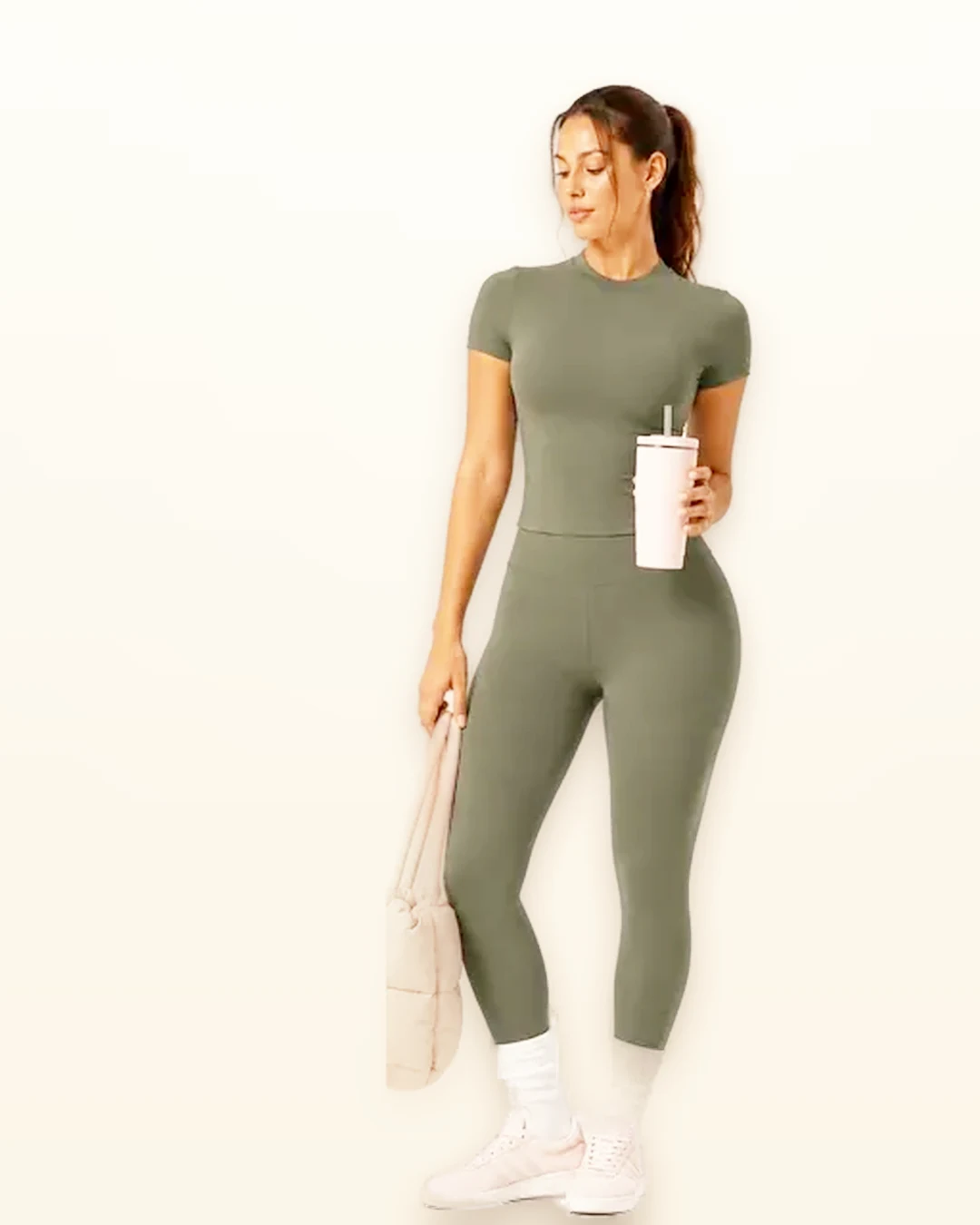 Model wearing a sage green mock-neck yoga set by Walundi yoga apparel factory